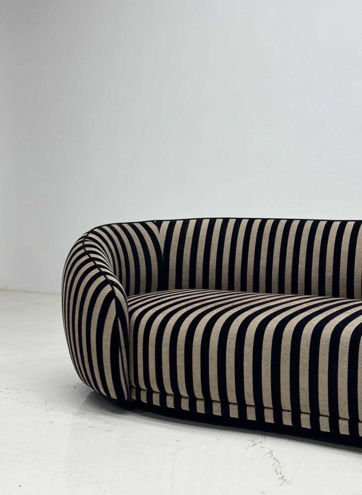 Black and Cream Striped Curved Sofa with Rounded Tubular Arms
