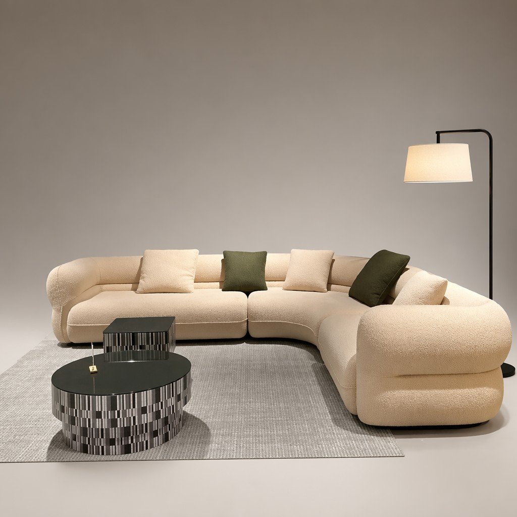 Cream Curved Sofa with Rolled Arms and Mixed Accent Pillows
